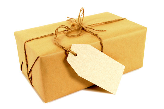 One single small brown paper package parcel tied with string with address label or gift tag isolated on white background photo