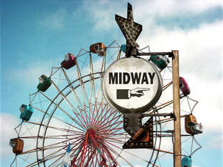 aged and worn vintage photo of midway way sign at carnival