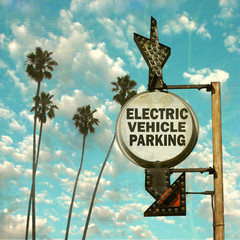 aged and worn vintage photo of electric vehicle parking sign