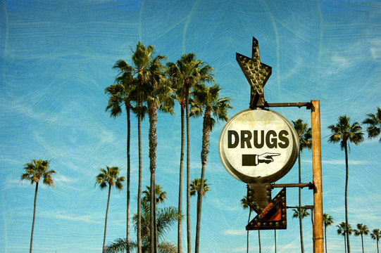 aged and worn vintage photo of drugs sign and palm trees