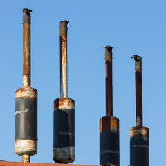 Exhaust pipes against the sky.