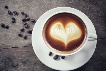 Vintage latte art coffee with beans