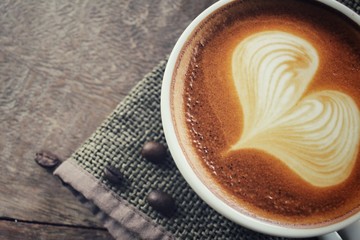 Vintage latte art coffee with beans