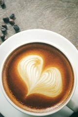 Vintage latte art coffee with beans