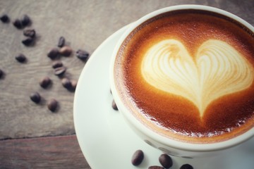 Vintage latte art coffee with beans