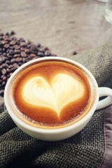 Vintage latte art coffee with beans