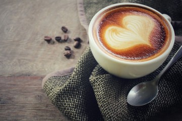 Vintage latte art coffee with beans