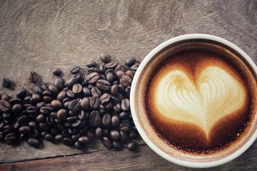 Vintage latte art coffee with beans