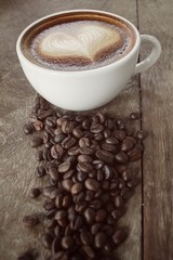 Vintage latte art coffee with beans