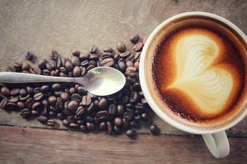 Vintage latte art coffee with beans