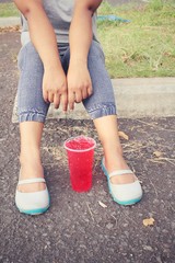 Woman and strawberry drink with shoes