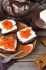 Bread and butter with caviar on a plate