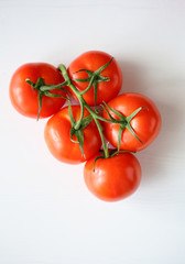 ripe tomatoes on branch