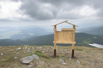 Wooden signboard in the mountain