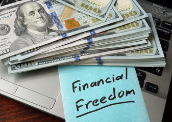 Financial Freedom  written on notebook with charts.