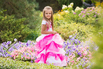 Obraz na płótnie Canvas Girl Princess in the garden flower bed