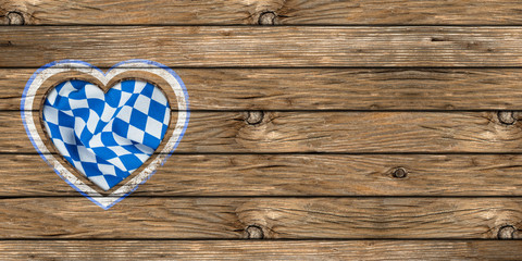 wooden oktoberfest background with heart shaped cut out  and bavarian flag