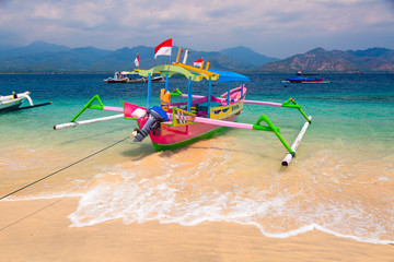 Colorful Indonesian boat at tropical sand beach in sunny day
