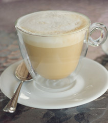 cup of cappuccino on the table in cafe. square crop