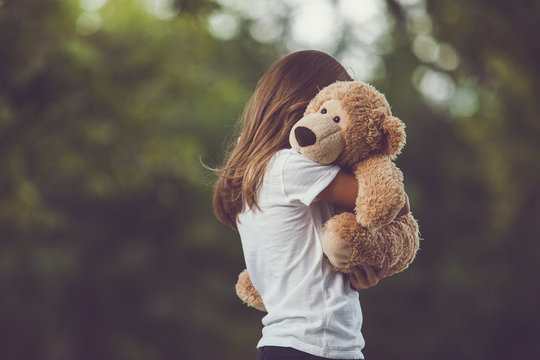 Naklejka Girl hugging a bear