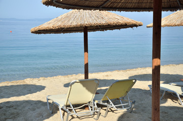 Beach straw parasols and chairs