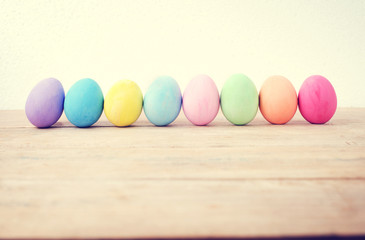 Vintage colorful easter eggs on wood table empty background