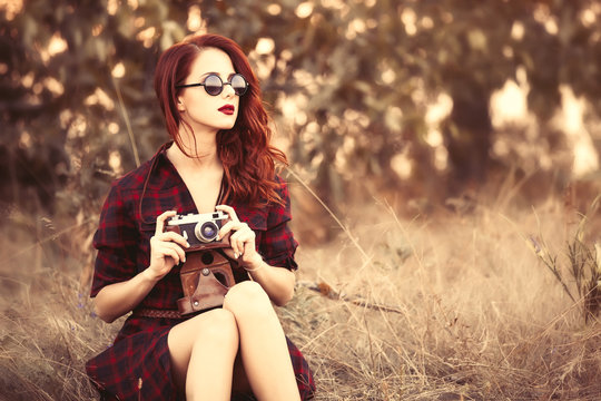 girl in plaid dress retro camera and sunglasses