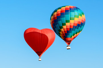 Two colored hot air balloon flying in the blue sky