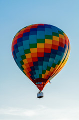 Colored hot air balloon flying in the blue sky