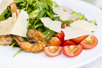 shrimp salad and greens on a white background