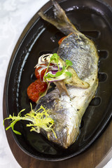 Fried fish dorado with vegetables and lemon