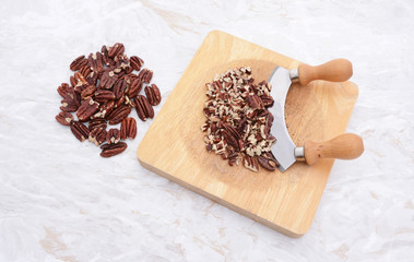 Toasted pecans with a rocking knife