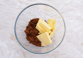 Pats of butter with dark soft sugar in a bowl