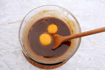 Stirring egg yolks into pecan pie filling