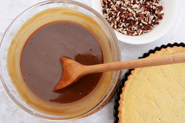 Making pecan pie - stirring the filling with a wooden spoon