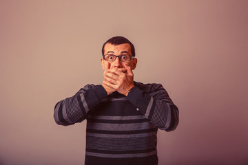 European-looking male of about thirty-closed mouth with her hand