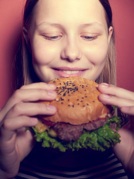 Teen Girl Eating A Burger