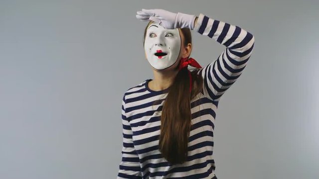 Woman mime looking through binoculars. Concept: Search