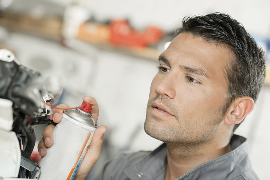 Mechanic Using Lubrication Spray