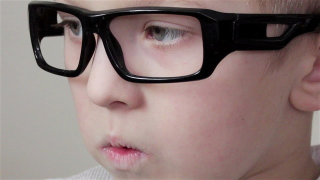view boy in glasses/closely watching TV handsome boy in the glasses without glass