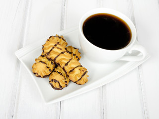 cup of coffee and delicious cakes on a white background
