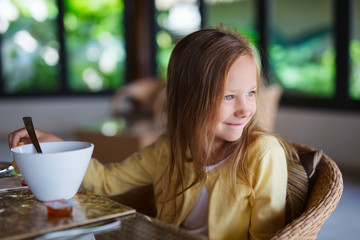 Little girl eating breakfast