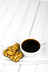 cup of coffee and delicious cakes on a white background