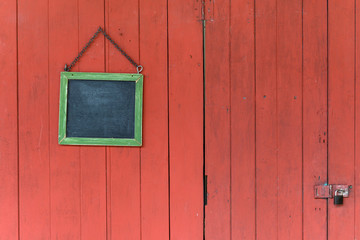 blackboard hanging on the old wooden door