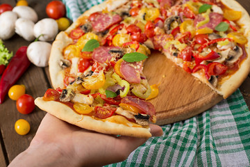 Pizza with salami, tomato, cheese and mushrooms