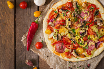 Pizza with salami, tomato, cheese and mushrooms. Top view - obrazy, fototapety, plakaty