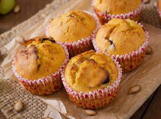 Appetizing and ruddy muffins with pumpkin and grapes