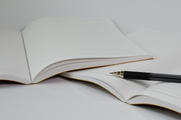 Notebook Open and Pen On White Background.