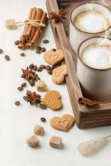 Tow cup of cappuccino with cookies as hearts
