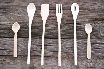Wooden cutlery set on wooden background